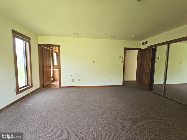 unfurnished bedroom featuring a closet, visible vents, carpet, and baseboards