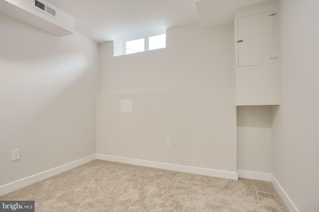 basement featuring visible vents, carpet, and baseboards
