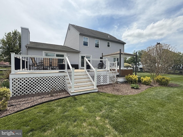 back of property with a lawn, a deck, cooling unit, and a chimney