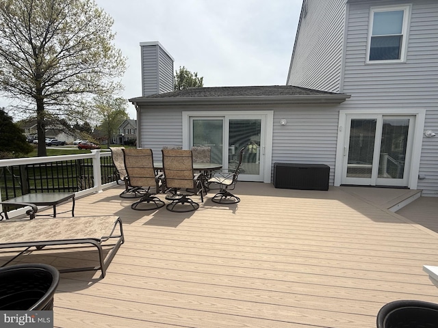 wooden terrace featuring outdoor dining area