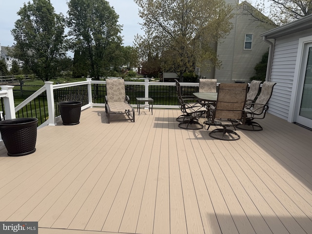 wooden terrace featuring outdoor dining space