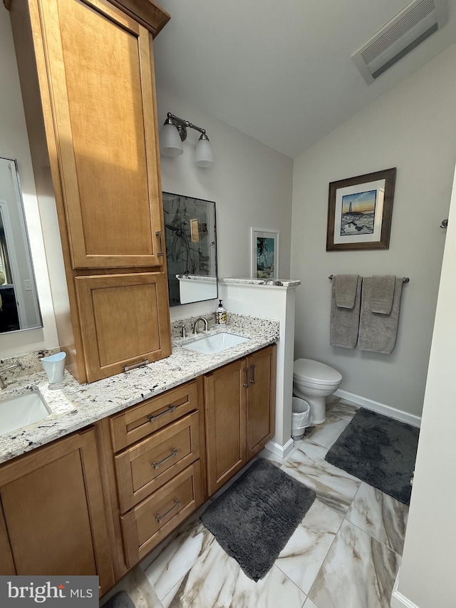 full bathroom featuring visible vents, vaulted ceiling, double vanity, and a sink