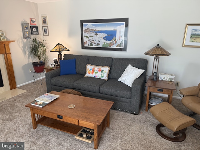 carpeted living area with baseboards