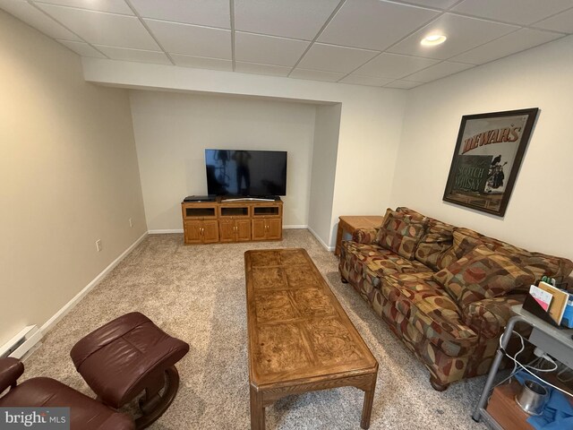 carpeted living area with a baseboard radiator, a drop ceiling, recessed lighting, and baseboards