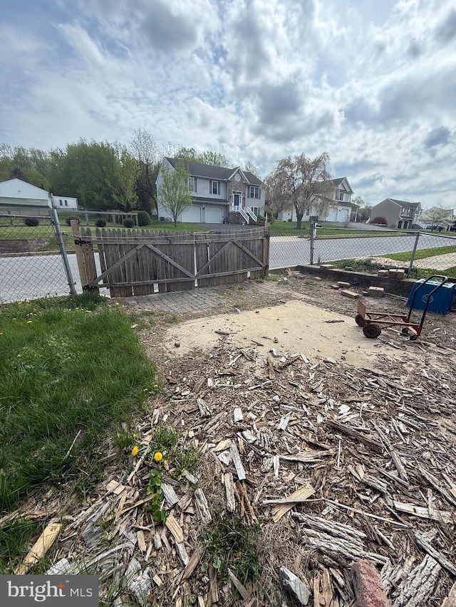 view of yard featuring fence and a residential view
