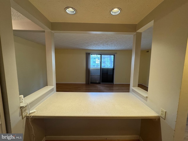 hallway featuring recessed lighting and a textured ceiling