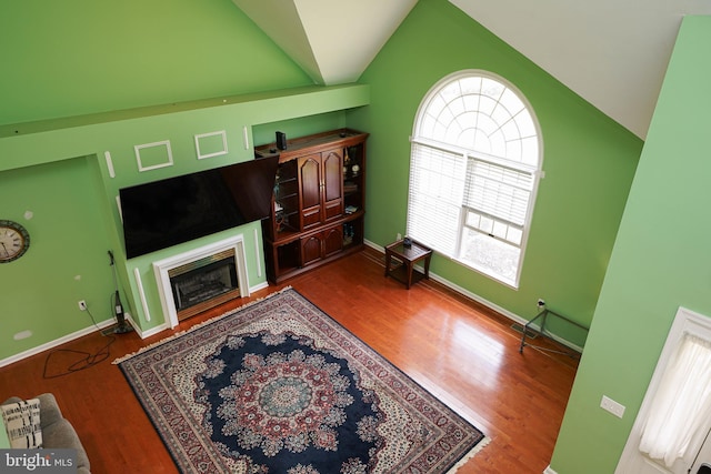30085 Haymarket Ct, Salisbury, MD 21804 - living area featuring vaulted ceiling, wood finished floors, a glass covered fireplace, and baseboards