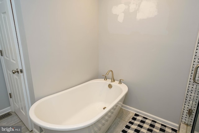 30085 Haymarket Ct, Salisbury, MD 21804 - full bathroom with a freestanding tub and baseboards