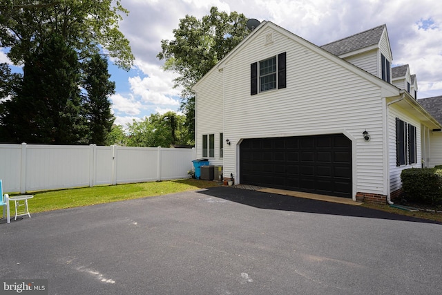 30085 Haymarket Ct, Salisbury, MD 21804 - view of side of property with driveway, fence, a garage, and a shingled roof
