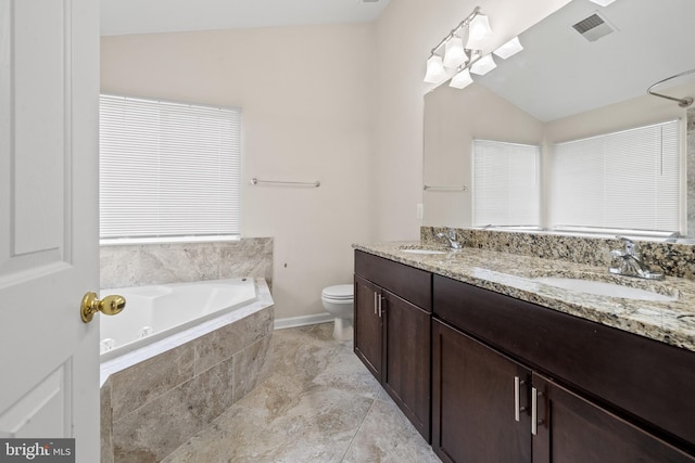 bathroom with visible vents, tiled bath, vaulted ceiling, and a sink