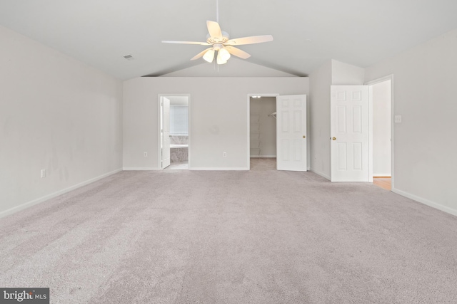 interior space featuring a ceiling fan, visible vents, lofted ceiling, and baseboards