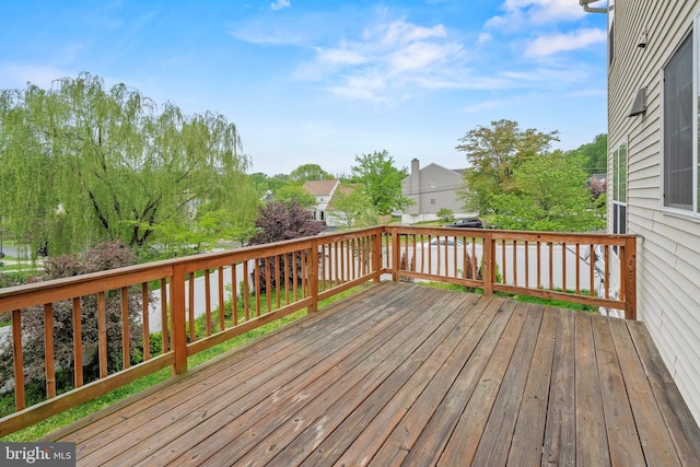 wooden terrace featuring a residential view