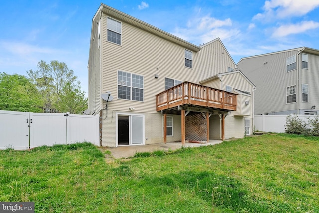 rear view of property with a gate, a fenced backyard, a deck, and a lawn