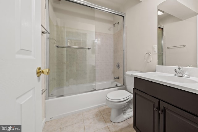 bathroom featuring tile patterned floors, vanity, toilet, and shower / washtub combination