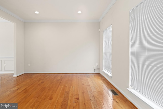 unfurnished room featuring visible vents, crown molding, light wood finished floors, and recessed lighting