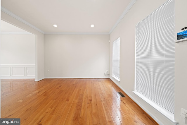 spare room featuring ornamental molding, visible vents, recessed lighting, and light wood-style flooring