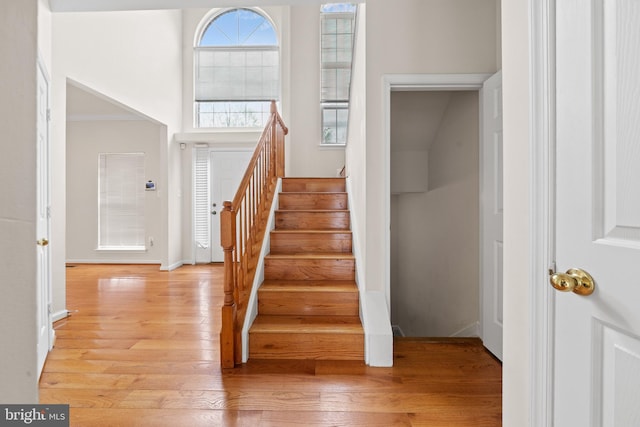 staircase with wood finished floors and baseboards