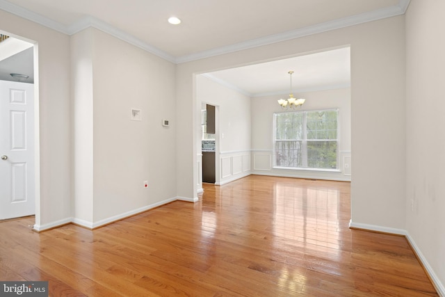 unfurnished room with a chandelier, baseboards, light wood finished floors, and recessed lighting