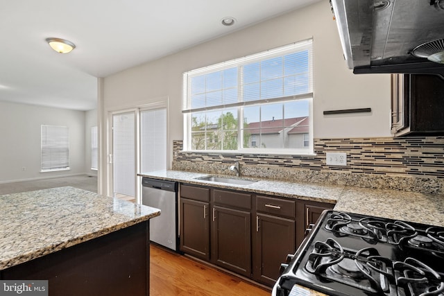kitchen with decorative backsplash, a sink, dark brown cabinets, dishwasher, and gas stove
