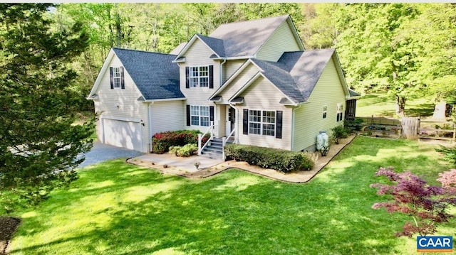 view of front of property featuring a front yard, a garage, driveway, roof with shingles, and fence