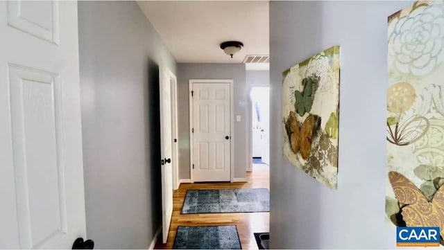 hallway with wood finished floors
