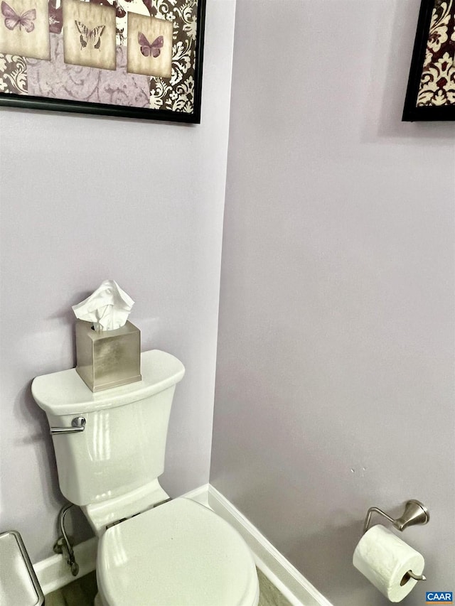 bathroom with toilet and baseboards