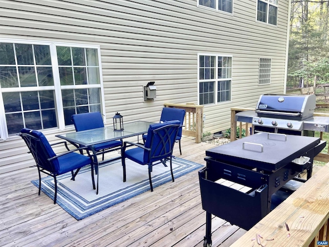 deck featuring area for grilling and outdoor dining area