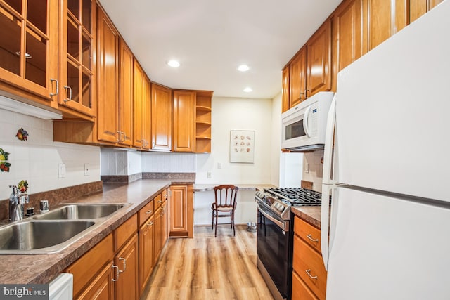 351 Gatewater Ct Unit C, Glen Burnie, MD 21060 - kitchen featuring white appliances, brown cabinets, light wood finished floors, a sink, and dark countertops