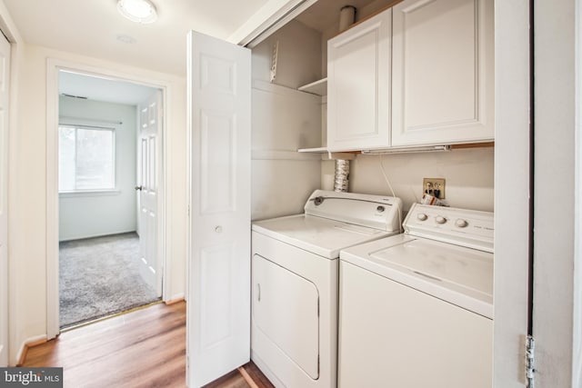 351 Gatewater Ct Unit C, Glen Burnie, MD 21060 - laundry area featuring cabinet space, washer and clothes dryer, and light wood-type flooring