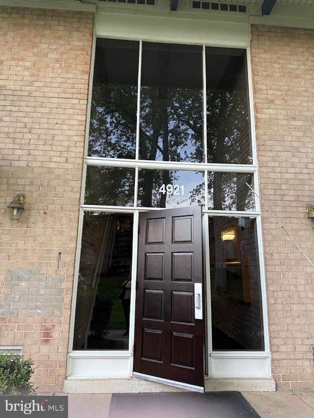 property entrance with brick siding