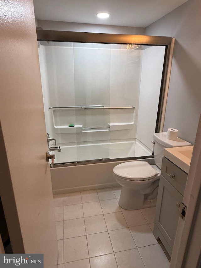 bathroom with recessed lighting, vanity, bath / shower combo with glass door, toilet, and tile patterned flooring