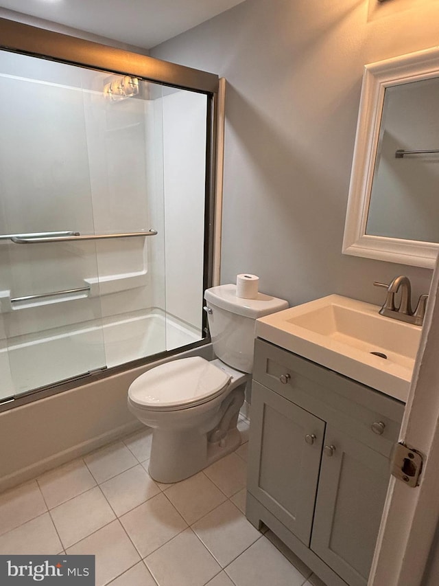 full bathroom featuring toilet, tile patterned flooring, shower / bath combination with glass door, and vanity