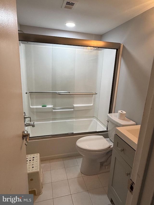 bathroom featuring tile patterned floors, enclosed tub / shower combo, toilet, vanity, and visible vents