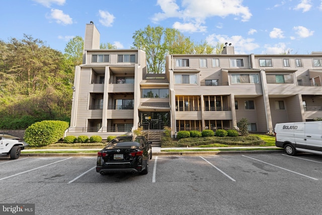 8101 Greenspring Way Unit 8101-E, Owings Mills, MD 21117 - view of building exterior featuring uncovered parking