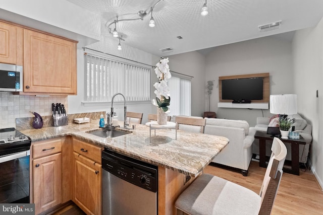 8101 Greenspring Way Unit 8101-E, Owings Mills, MD 21117 - kitchen with visible vents, appliances with stainless steel finishes, decorative backsplash, and a sink