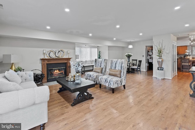 8101 Greenspring Way Unit 8101-E, Owings Mills, MD 21117 - living area featuring visible vents, recessed lighting, light wood finished floors, and a glass covered fireplace
