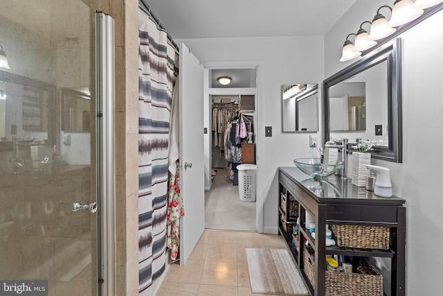 8101 Greenspring Way Unit 8101-E, Owings Mills, MD 21117 - bathroom featuring tile patterned floors, double vanity, a sink, a spacious closet, and a stall shower