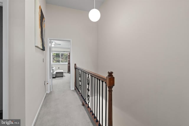 8101 Greenspring Way Unit 8101-E, Owings Mills, MD 21117 - hall featuring baseboards, an upstairs landing, and light colored carpet