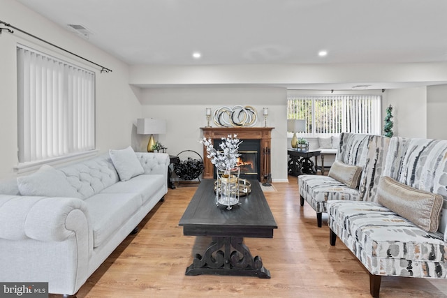 8101 Greenspring Way Unit 8101-E, Owings Mills, MD 21117 - living room featuring recessed lighting, visible vents, a glass covered fireplace, and light wood-type flooring