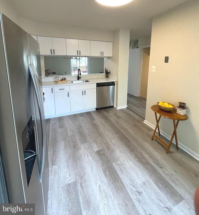 20002 Apperson Pl, Germantown, MD 20876 - kitchen featuring light wood-type flooring, a sink, light countertops, stainless steel appliances, and white cabinetry