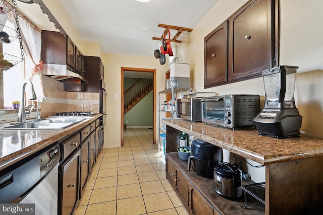 kitchen featuring a sink, a toaster, dark brown cabinetry, and stainless steel appliances