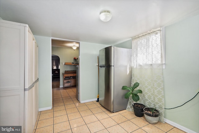 bathroom featuring baseboards and tile patterned flooring