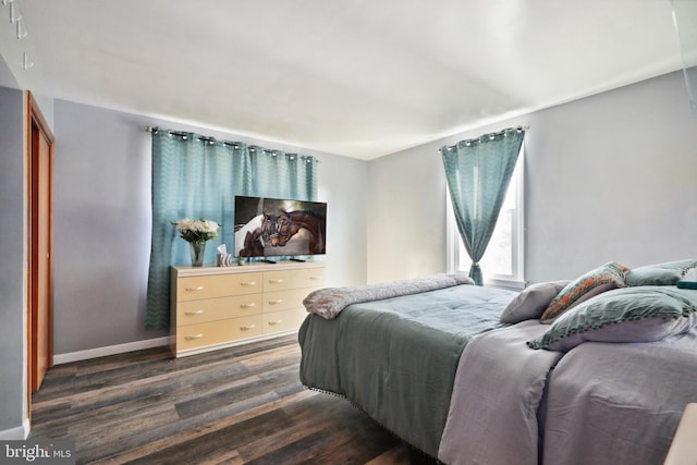 bedroom with baseboards and dark wood-style floors