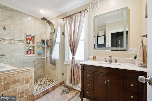 full bathroom with visible vents, crown molding, tile patterned flooring, a shower stall, and vanity
