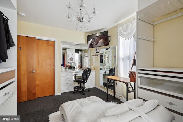 bedroom with an inviting chandelier and dark colored carpet