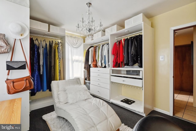 spacious closet featuring a notable chandelier and carpet
