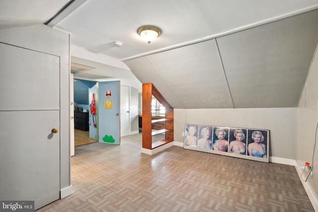 bonus room featuring baseboards and lofted ceiling