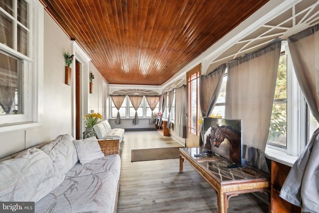 sunroom / solarium featuring wood ceiling and wood finished floors