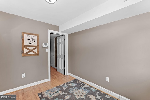 bedroom with light wood-style flooring and baseboards