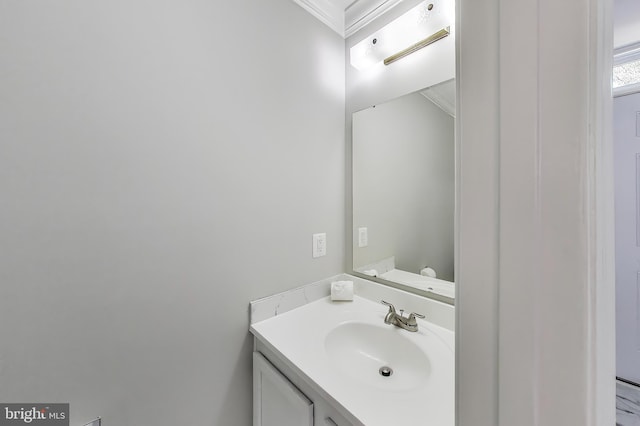 bathroom with crown molding and vanity